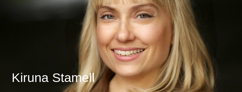 A close up image of a person smiling at the camera with the words "Kiruna Stamell" displayed to the left of the screen. 